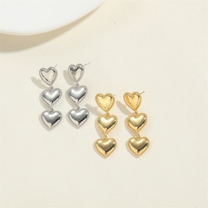 Three-tiered heart drop earrings in polished gold and silver with beaded edge accents