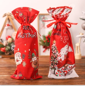 Christmas wine bottle gift bags with Santa and elk patterns on a festive wooden table