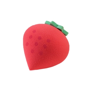 Strawberry-shaped makeup sponge in red with green leaf detail for dry and wet cosmetic use
