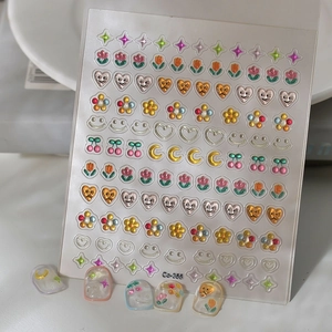 3D embossed nail art stickers with heart and smile patterns on white background