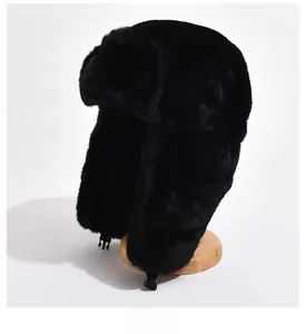 Detail of black faux fur trapper hat featuring warm plush texture and plastic chin buckle