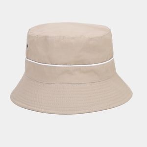 Detail of khaki waterproof sun hat featuring metal eyelets and white decorative piping trim