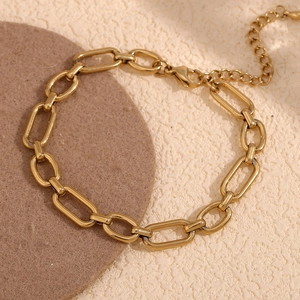 Macro shot of 14K gold plated paperclip chain anklet with adjustable lobster clasp detail