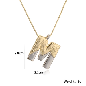 Detail view of the letter M pendant with two-tone finish and size specs 2.8cm x 2.2cm