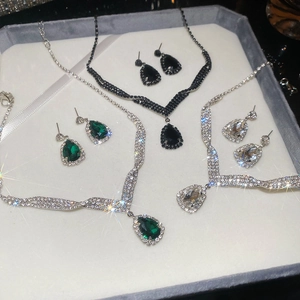 Detailed view of teardrop crystal jewelry sets in black, green, and clear colors