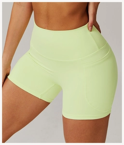 Close-up of high-waist neon green yoga shorts with elastic fabric and side pocket detail
