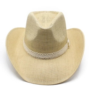 Detail of western straw cowboy hat featuring elegant white lace ribbon and woven texture