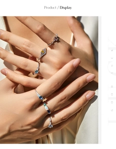 Detail of s925 silver rings with colorful opal and emerald crystals on fingers