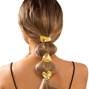 Golden geometric hair clips set with heart triangle and rectangle on braided hair