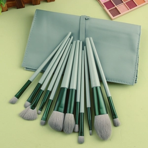 Detail of 12-piece soft fiber makeup brush set with green handles and PU zipper bag