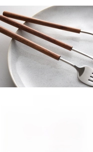 Detail of 304 stainless steel flatware set featuring pearwood handles and mirror polish
