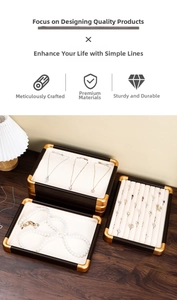 Detail of walnut wood jewelry display set with ivory velvet lining for rings and necklaces