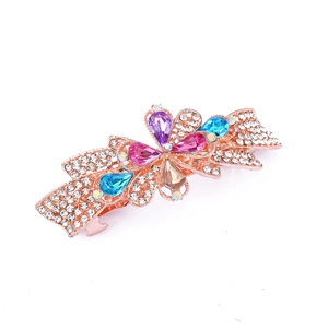 Detail of rose gold alloy hair clip with colorful gemstones and pavé rhinestones