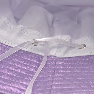 Macro view of purple shimmer fabric bucket hat with white drawstring and metal eyelet