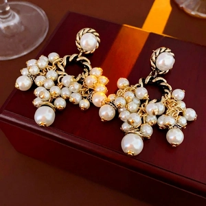 Vintage cluster pearl drop earrings with golden twist texture and retro luxury style