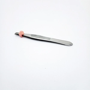 Silver stainless steel lash tweezers with slanted tip and pink heart-shaped protective cap