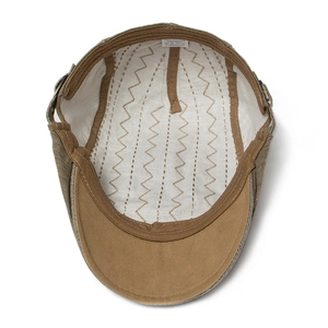 Internal view of brown cotton flat cap showing lining quality and 100% cotton label