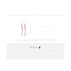Detail showing long strawberry crystal tassel earrings with silver needles and copper chain