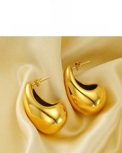 Detail of 18K gold plated teardrop earrings on champagne satin with lead-free quality label