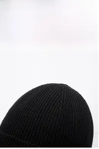 Close-up of black ribbed knit beanie with thick vertical texture and thermal design
