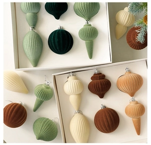 Detailed view of flocked Christmas ornaments in earth tones with soft velvet textures