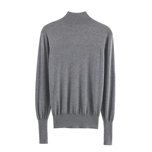 Deep grey mock neck knit sweater with ribbed cuffs and lantern sleeves on white background