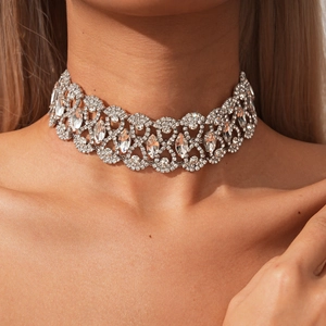 Detailed macro view of an ornate silver rhinestone choker with hollow geometric patterns