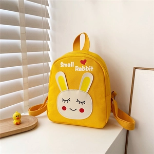 Close-up of bright yellow canvas kid's backpack featuring Small Rabbit print and top handle