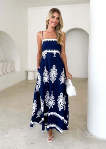 Detailed close-up of navy blue ethnic maxi dress with white totem prints and texture