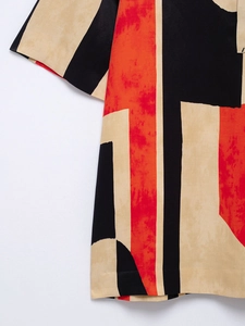 Detail of soft fabric with black and beige geometric abstract print on women's shirt