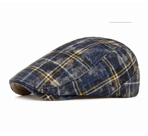 Detailed close-up of British style navy blue plaid flat cap with washed cotton texture