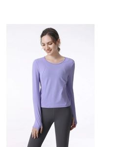 Detail view of purple sports top featuring thumbhole cuffs and breathable elastic fabric