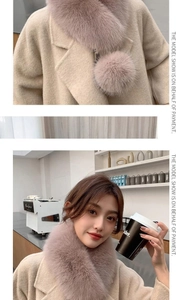 Detail of soft faux fur collar with pom-pom ribbon and warm woolen coat texture