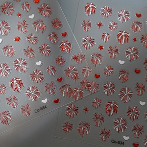 Macro view of 3D embossed red and white firework nail art stickers with heart patterns