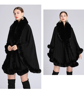 Close-up of the plush faux rabbit fur trim on the collar of a black knit shawl