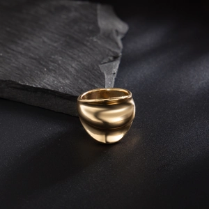Macro detail of men's vintage golden irregular ring with polished fluid design