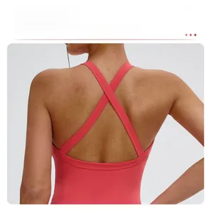 Close-up of coral pink yoga bra featuring criss-cross back straps for athletic support