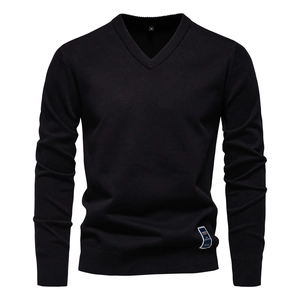 Detailed close-up of V-neck neckline and knit texture on a black men's cotton sweater
