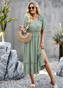 Detailed view of sage green V-neck midi dress with elastic waist and ruffled hemline