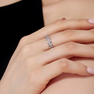 Detailed close-up of a S925 sterling silver ring with oval crystals worn on finger