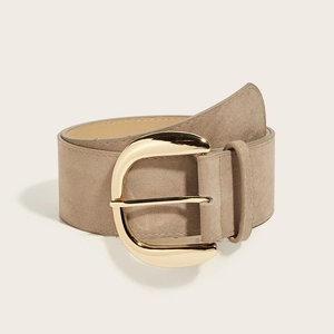 Macro view of taupe suede wide waist belt featuring a polished gold oval buckle