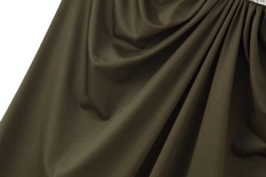 Detailed macro view of olive green fabric texture with sparkling rhinestone accents