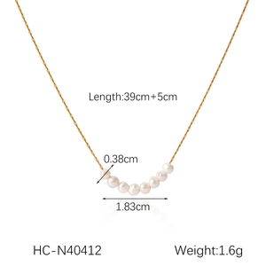 Detail view of gold stainless steel necklace with dimensions 39cm+5cm and small pearls