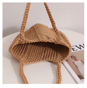 Detailed macro view of the natural beige cotton rope weaving texture on the tote bag
