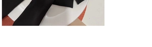 Detail shot of the black ribbon texture and layered fabric folds of the bow hair clip