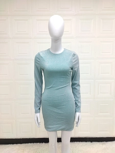 Detail of mint green bodycon dress featuring shimmering glitter fabric and long sleeves