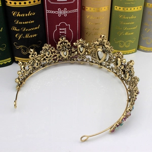 Detailed close-up of a vintage gold alloy bridal crown featuring colorful rhinestones