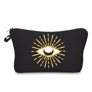 Detailed view of black travel cosmetic bag with golden evil eye print and side loop handle