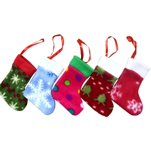 Set of five felt Christmas stockings with colorful patterns and red hanging loops