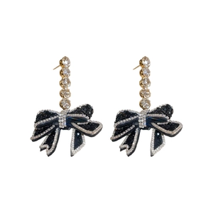 Silver needle bowknot tassel earrings with black rhinestones and crystals on white background
